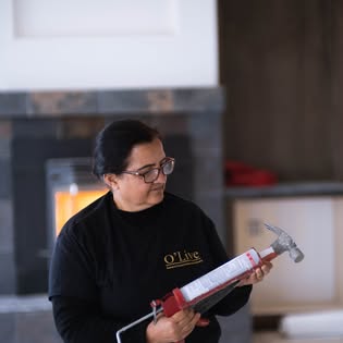 Crew member preparing caulk for an interior project