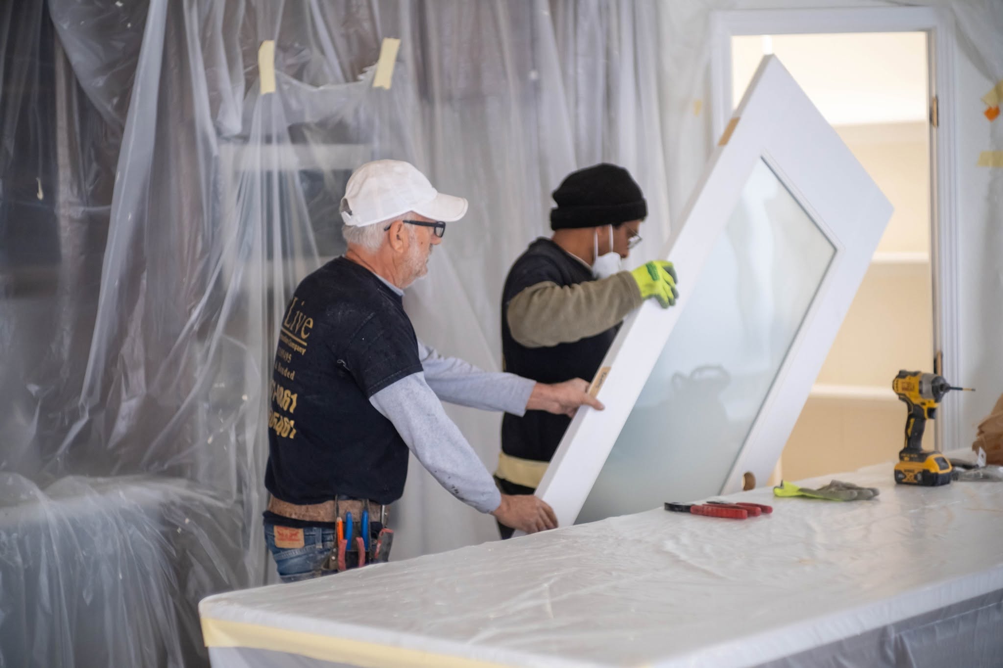 O’Live Construction crew installing a residential door